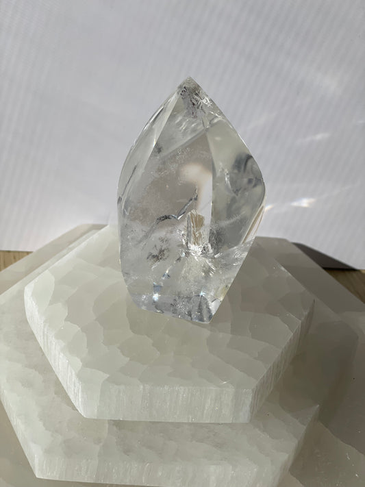 Lemurian Flame quartz crystal with on decorative geometric stand.