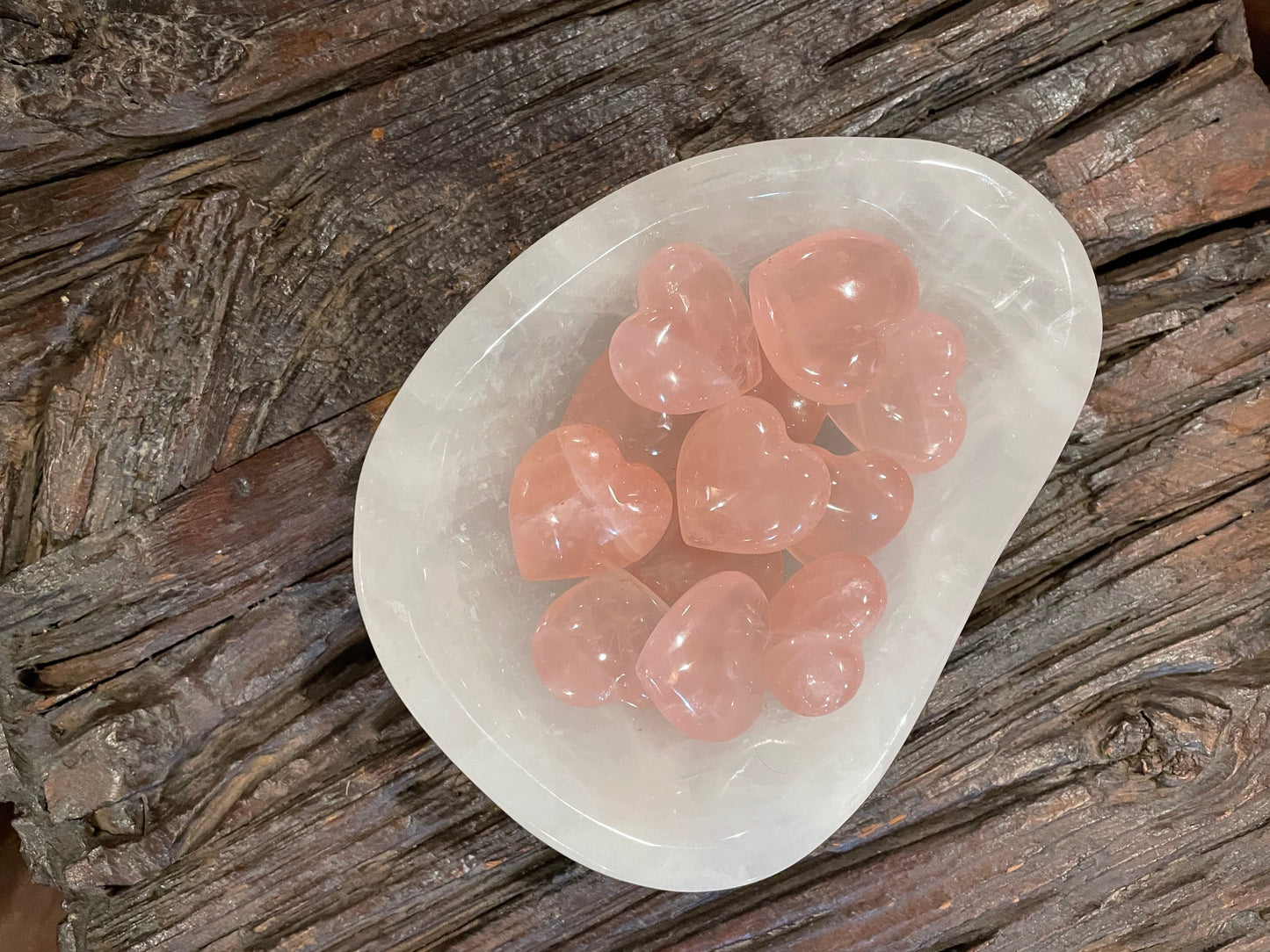 Rose Quartz heart collection in a dish for spiritual and emotional balance.