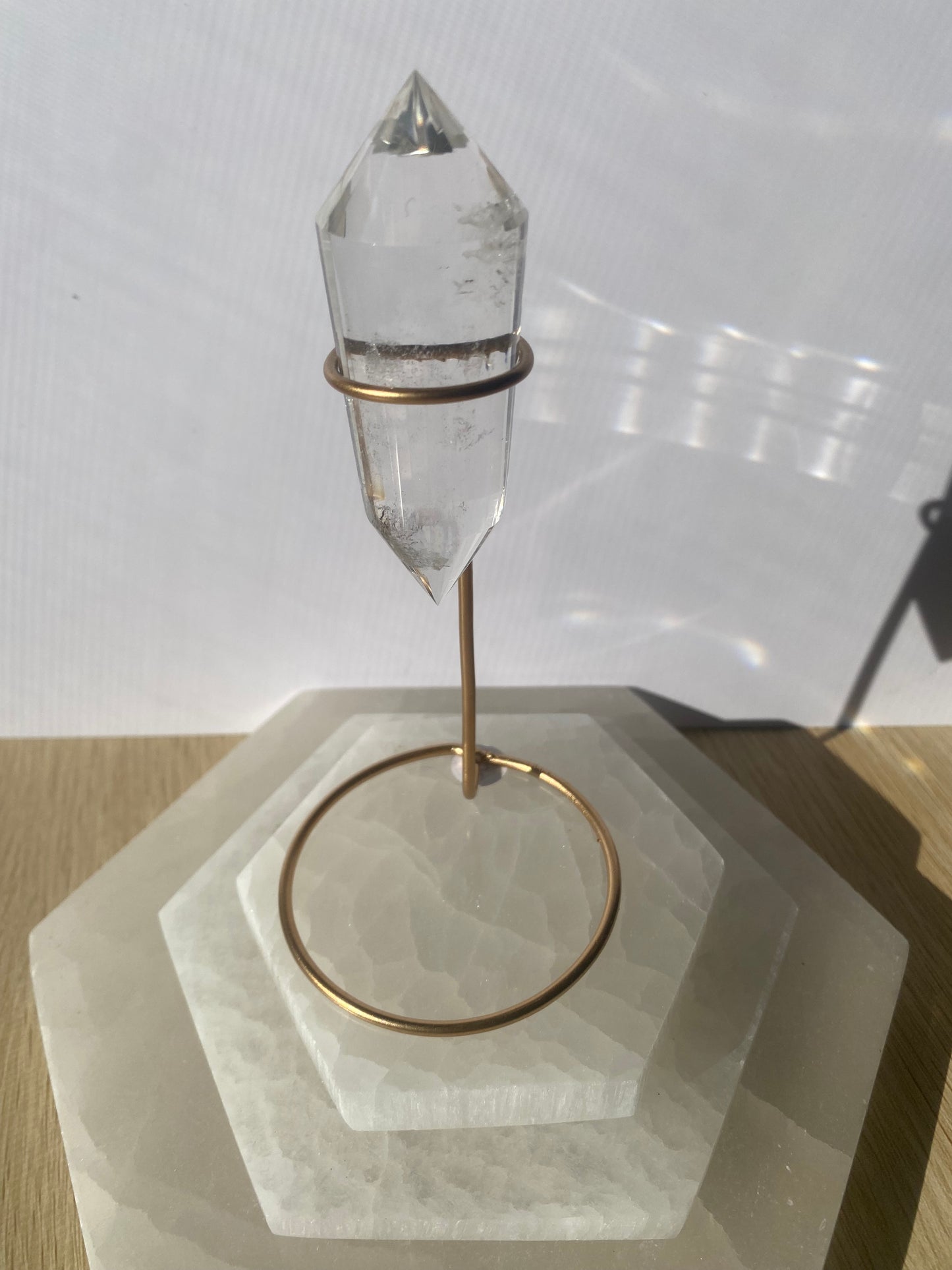 Lemurian Vogel crystal sculpture with bronze base on geometric stand.