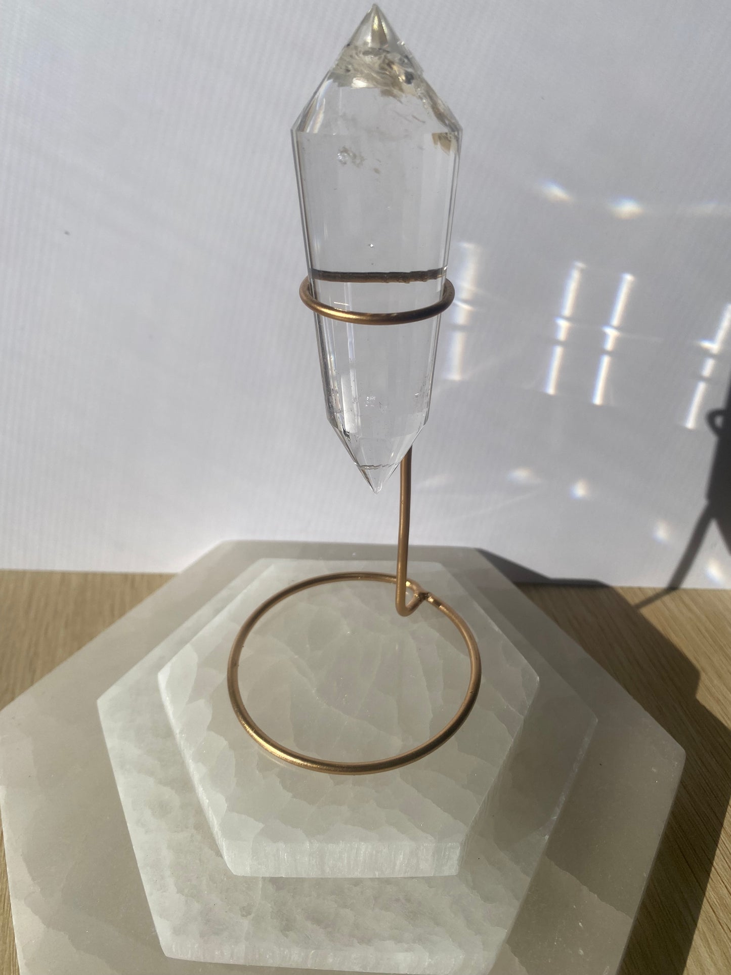 Lemurian Vogel crystal sculpture with bronze base on geometric stand.