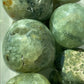 Close-up of greenish-brown marbled stones on a white background