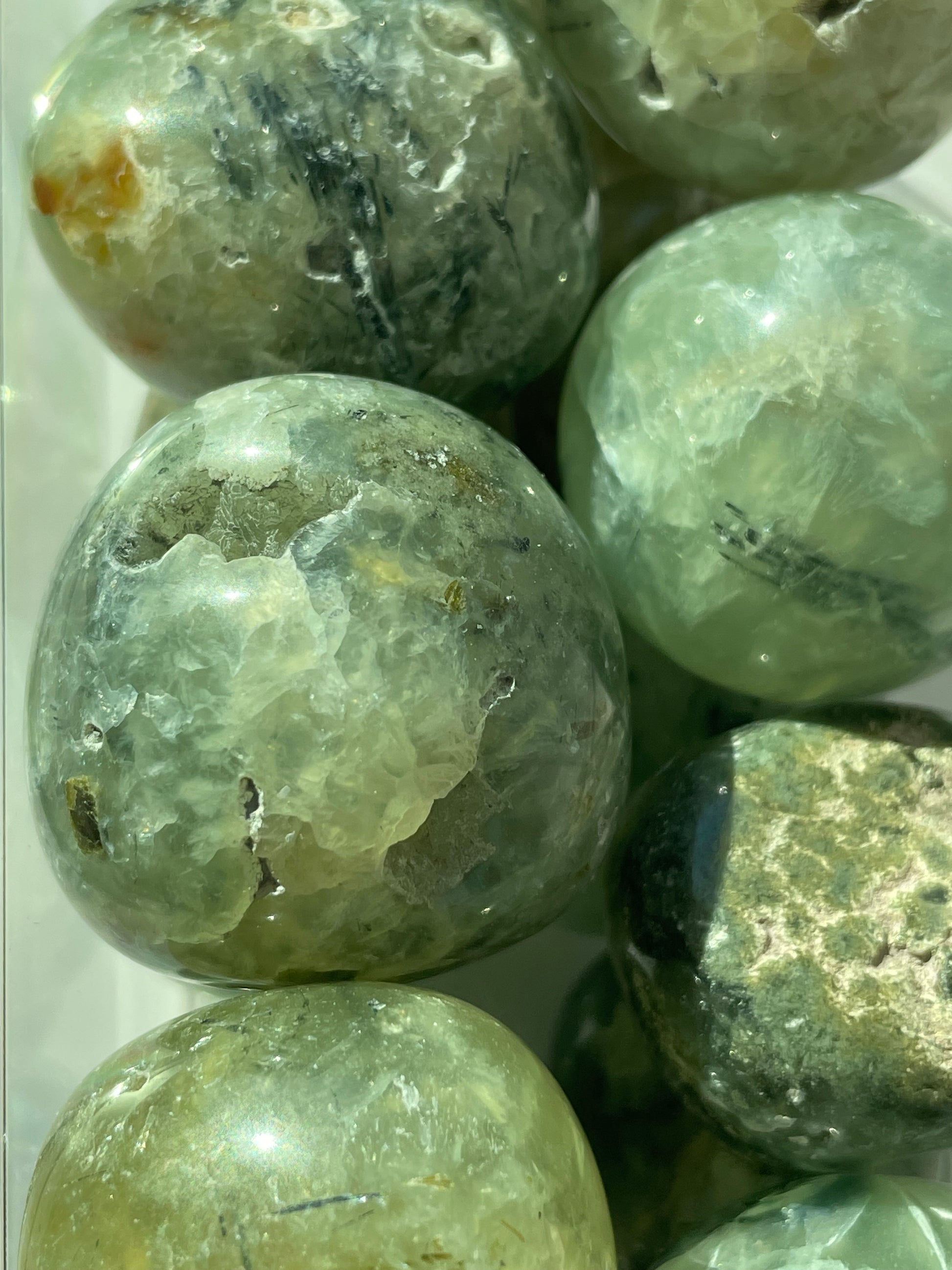 Close-up of greenish-brown marbled stones on a white background