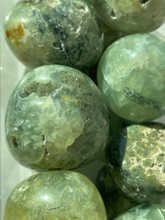 Close-up of greenish-brown marbled stones on a white background