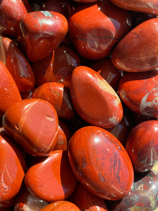 Close-up of red jasper stones with a rough texture.