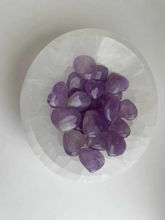 Purple crystals on a white stone surface.