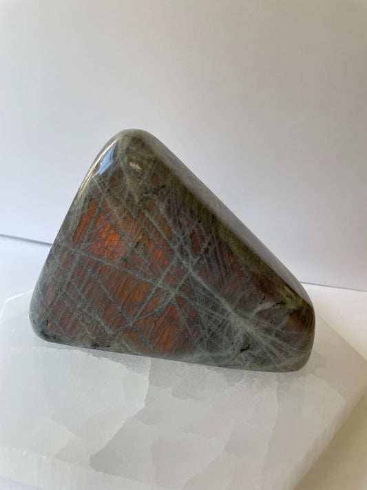 Polished Labradorite freeform crystal displayed on a white background.
