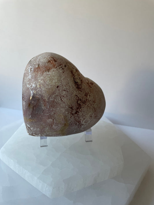 Heart-shaped stone on a white background.