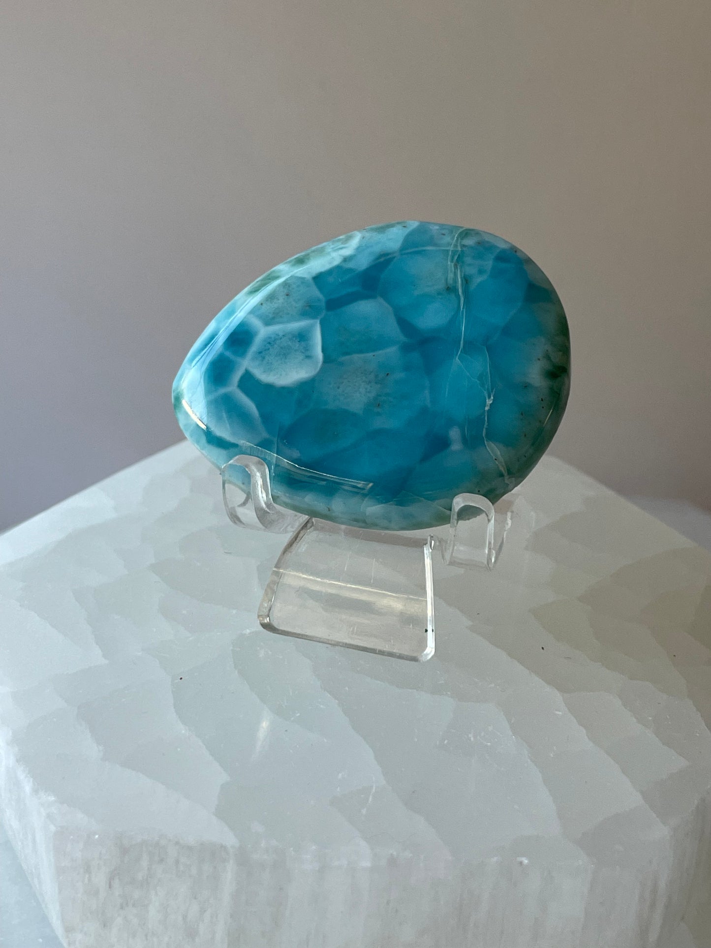 Natural Larimar palmstone gemstone with soft sky blue tones