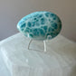 Larimar palmstone with smooth polished surface on white background