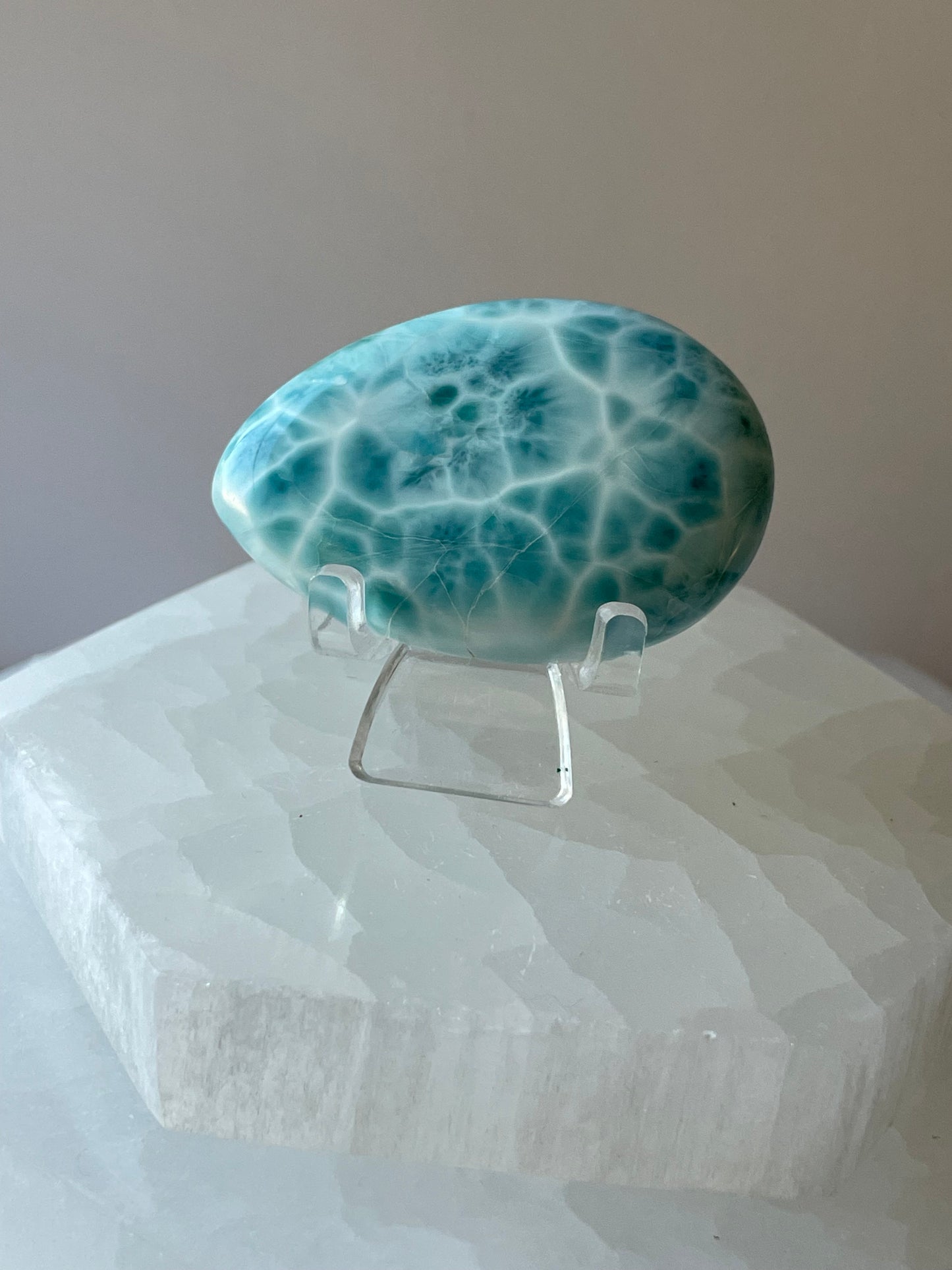 Larimar palmstone with smooth polished surface on white background