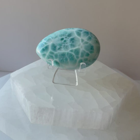 Blue Larimar palmstone shown in a woman’s hand, video clip