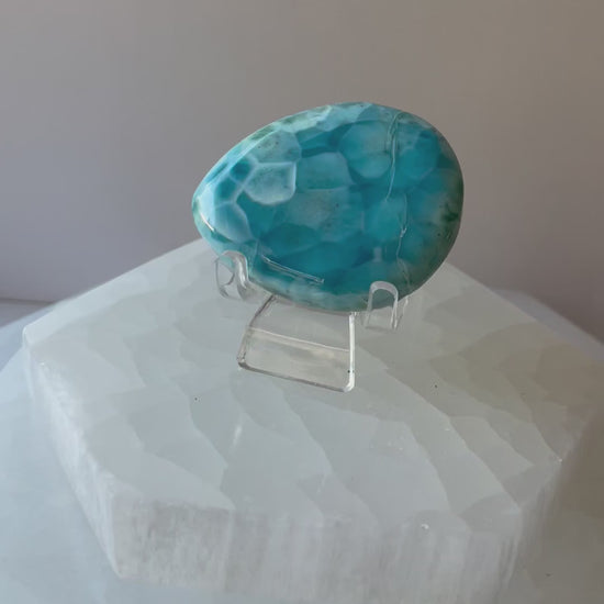 Larimar palmstone resting in a female hand, short video